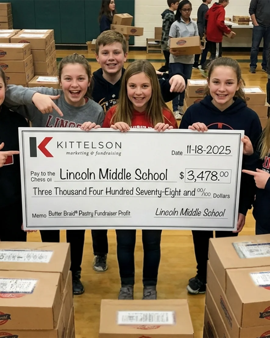 Lincoln Middle School students celebrating their Butter Braid fundraiser success with a profit check